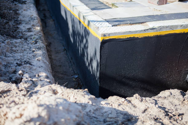 Professional Waterproofing technician working in Bloomington, IN